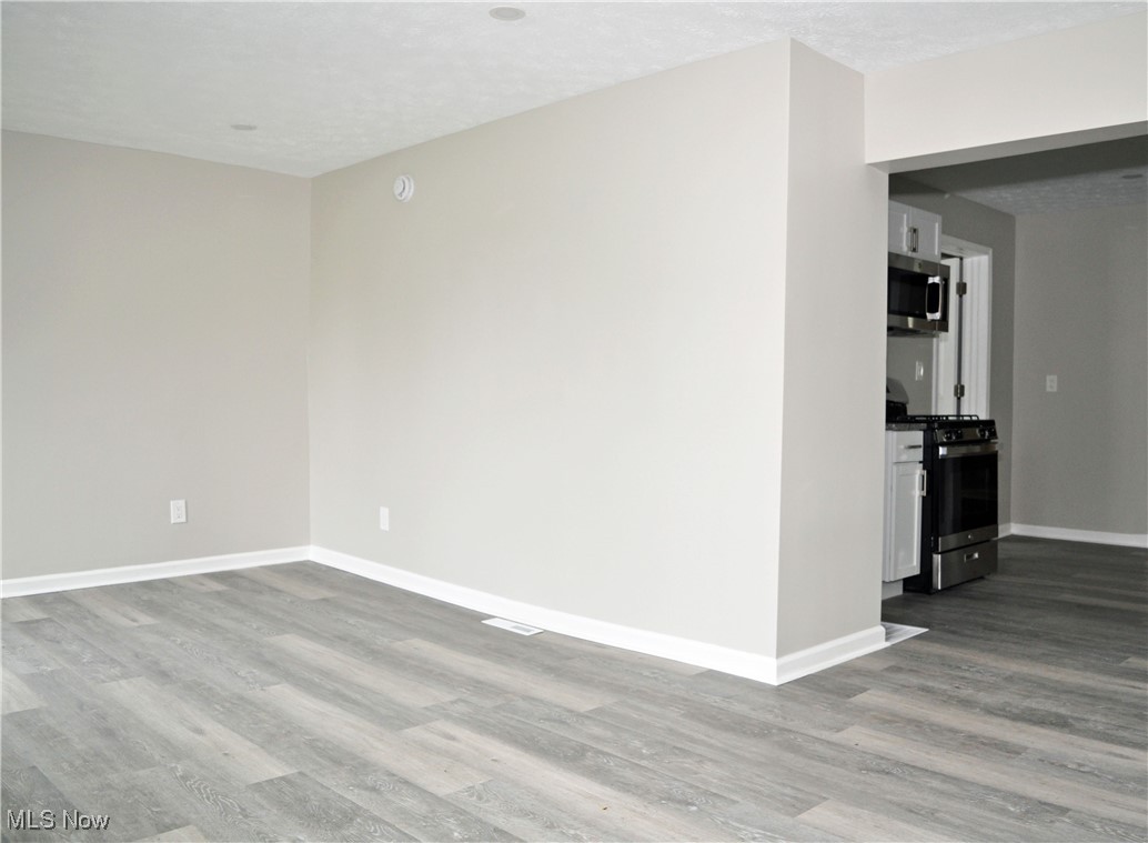 7604 Spafford Road Cleveland, OH 44105 - Photo 14 of 23 Spare room with wood finished floors and baseboards