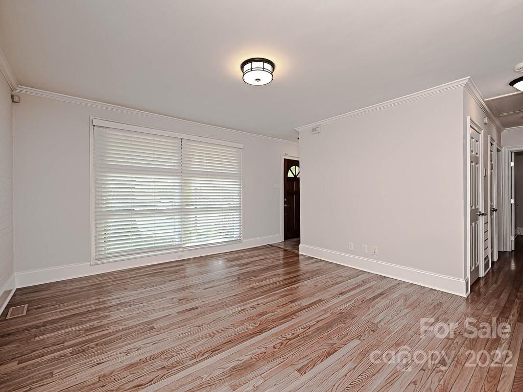4212 Randolph Road Charlotte, NC 28211 - Photo 15 of 23 a view of an empty room with wooden floor and a window