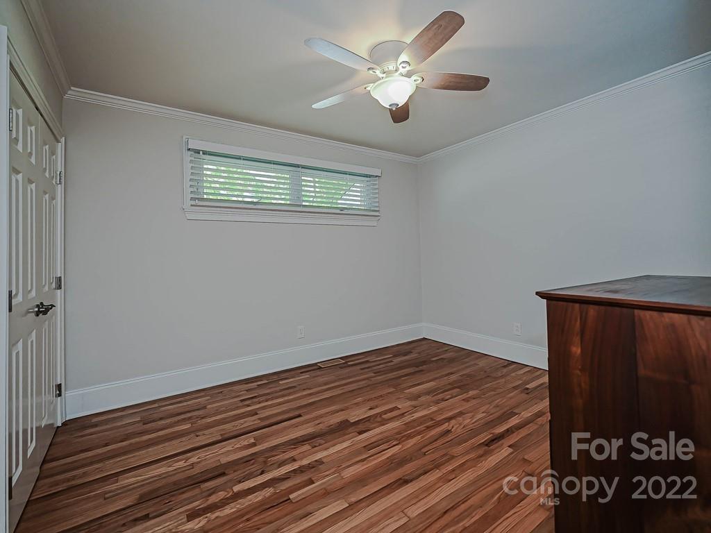 4212 Randolph Road Charlotte, NC 28211 - Photo 16 of 23 a view of a room with wooden floor and ceiling fan