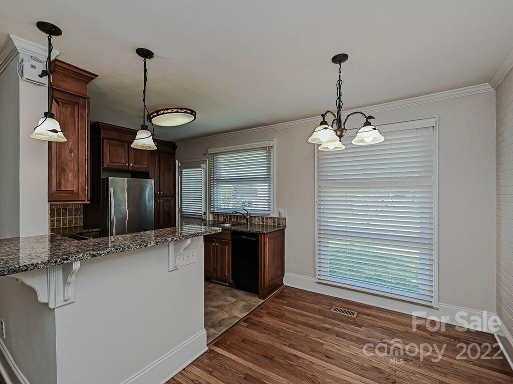 4212 Randolph Road Charlotte, NC 28211 - Photo 6 of 23 a kitchen with stainless steel appliances granite countertop a sink and a stove
