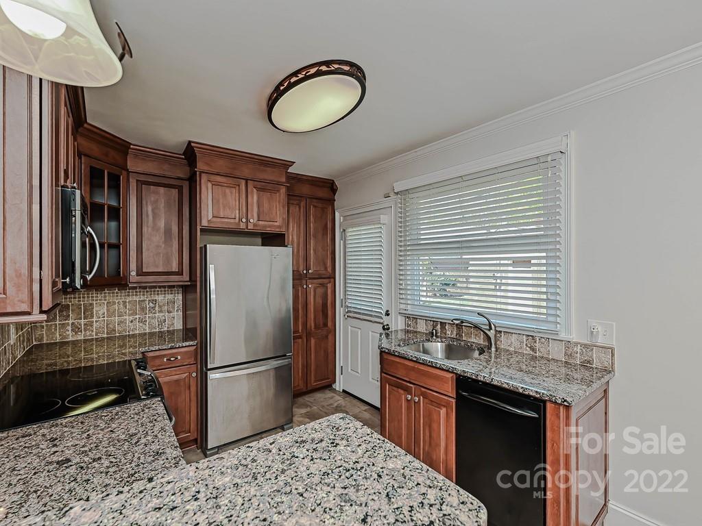 4212 Randolph Road Charlotte, NC 28211 - Photo 7 of 23 a kitchen with granite countertop stainless steel appliances a refrigerator a stove a sink and cabinets