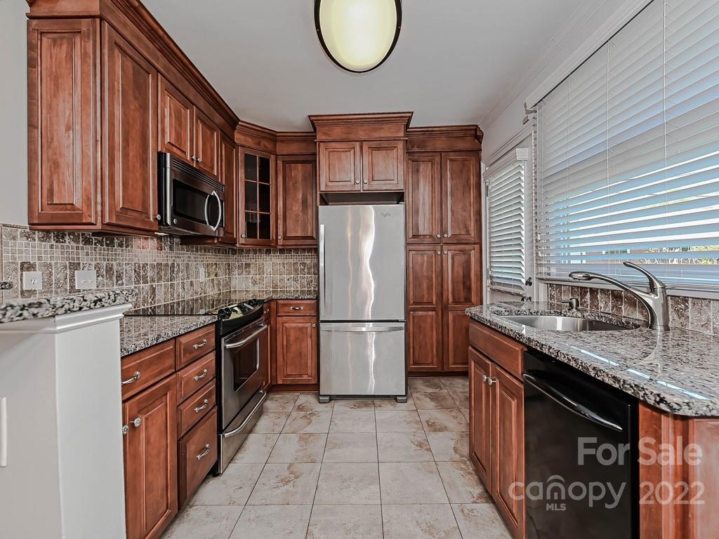 4212 Randolph Road Charlotte, NC 28211 - Photo 8 of 23 a kitchen with stainless steel appliances granite countertop a stove refrigerator and a microwave