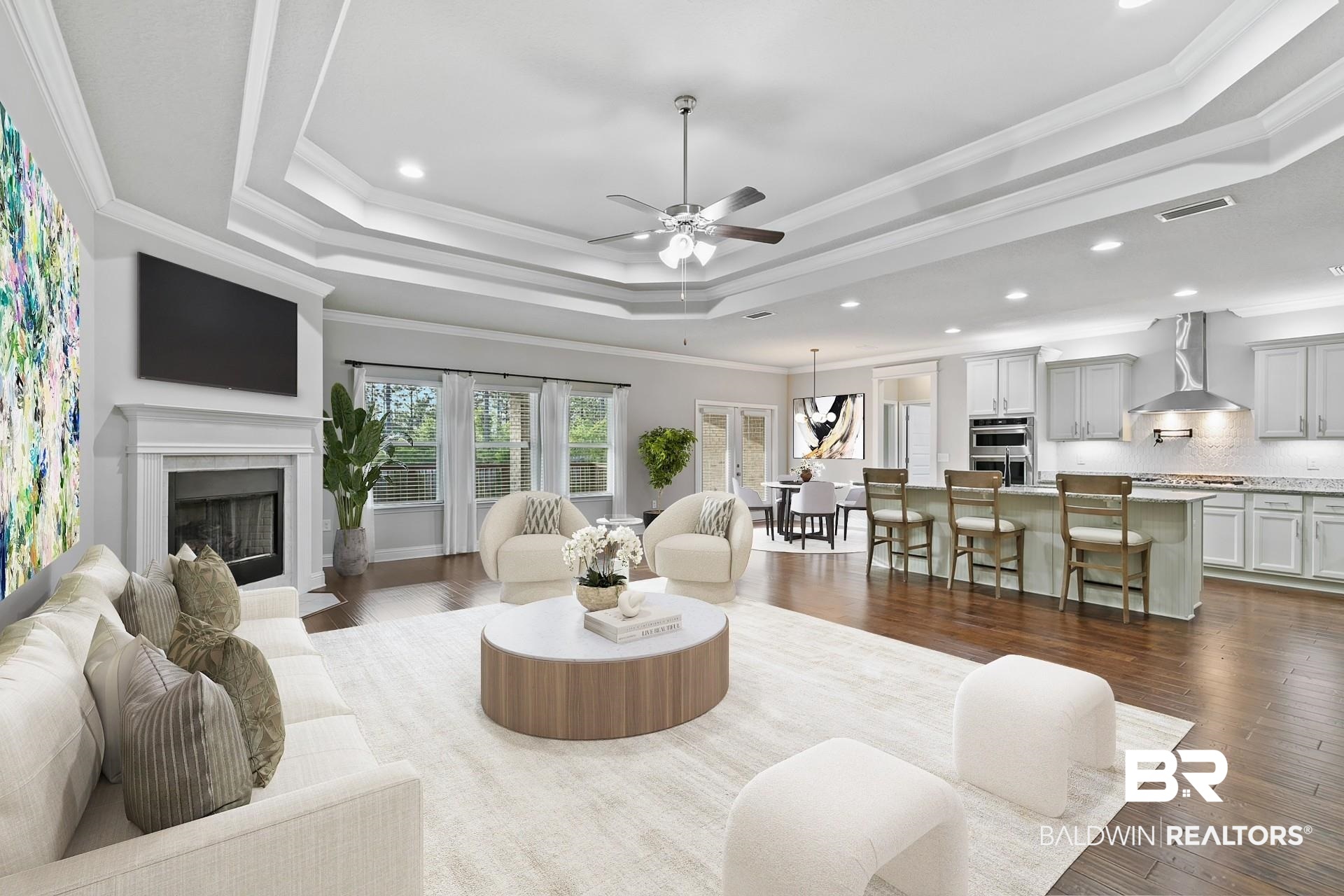 31625 Spoonbill Road Daphne, AL 36527 - Photo 16 of 49 Living room with dark hardwood / wood-style flooring, ceiling fan, a raised ceiling, and ornamental molding