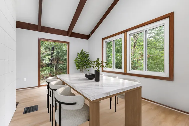 a view of a dining room with furniture window and outside view