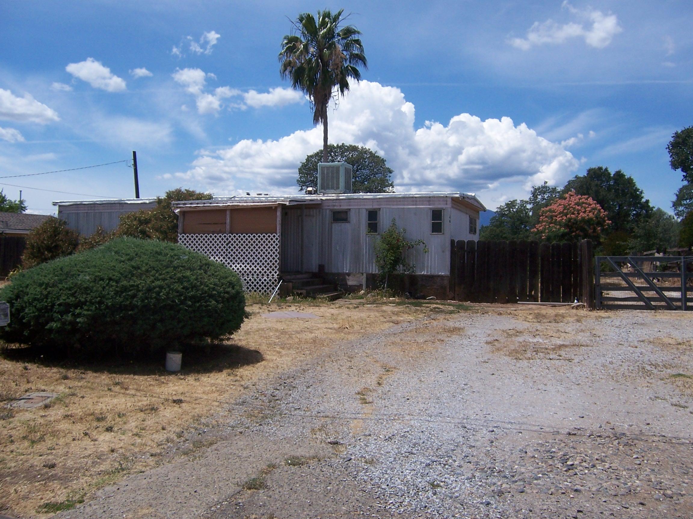 Scott Road Redding, CA 96003 - Photo 3 of 22 a front view of a house with a yard and garage