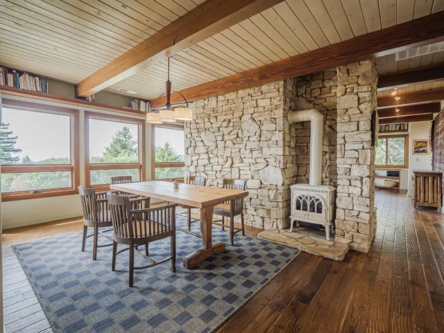 a bedroom with a bed window and a table