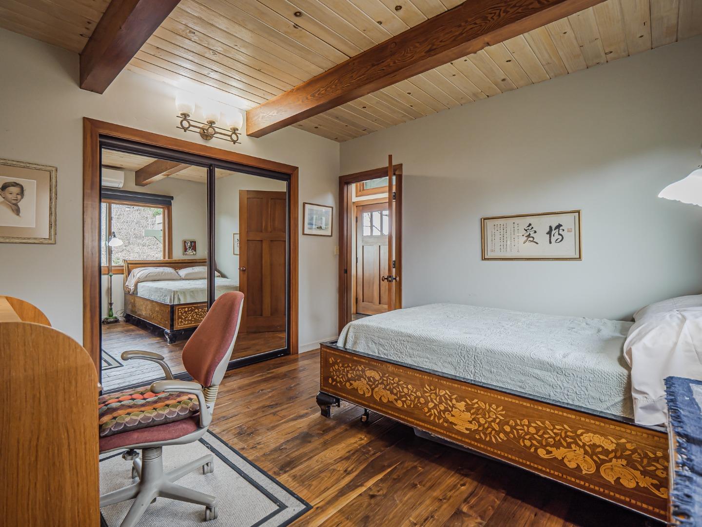 1584 Tindall Ranch Road Corralitos, CA 95076 - Photo 27 of 104 a bedroom with a bed and wooden floor