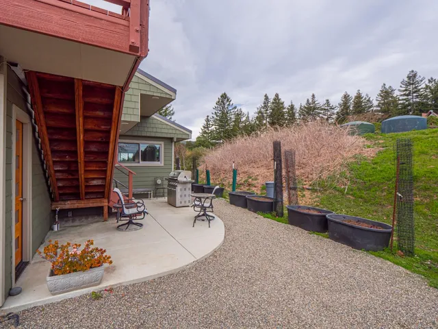 a view of a backyard with wooden fence