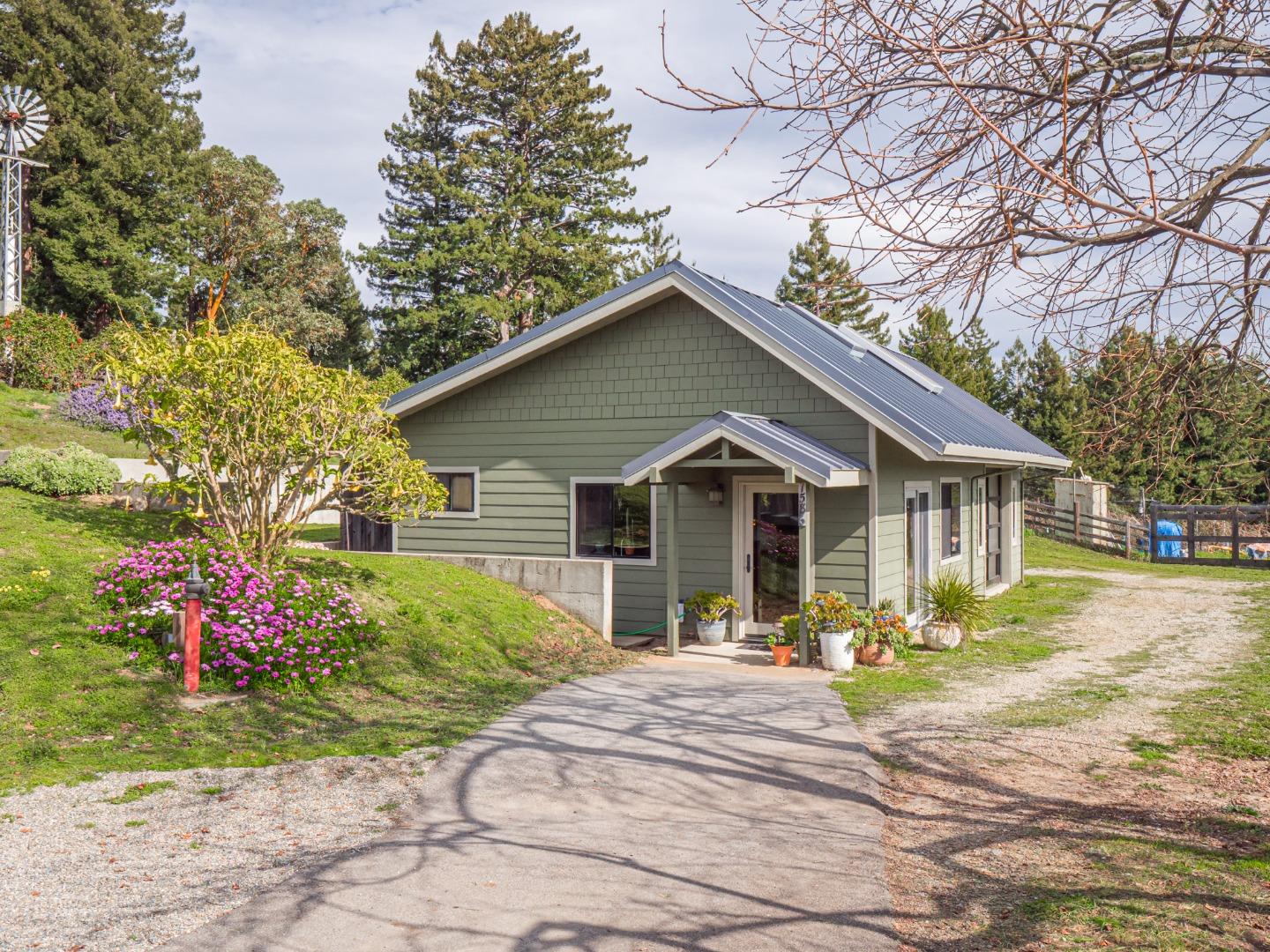 1584 Tindall Ranch Road Corralitos, CA 95076 - Photo 66 of 104 a front view of a house with a yard and outdoor seating