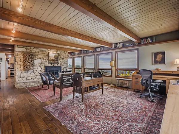 a kitchen with stainless steel appliances a refrigerator and wooden floor