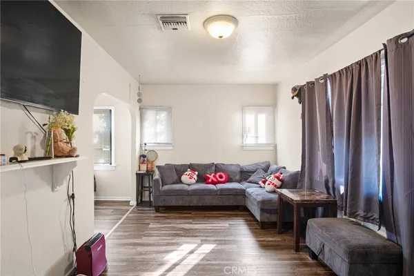 a living room with furniture window and wall painting