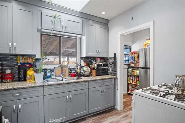 a view of a kitchen with fridge and workspace