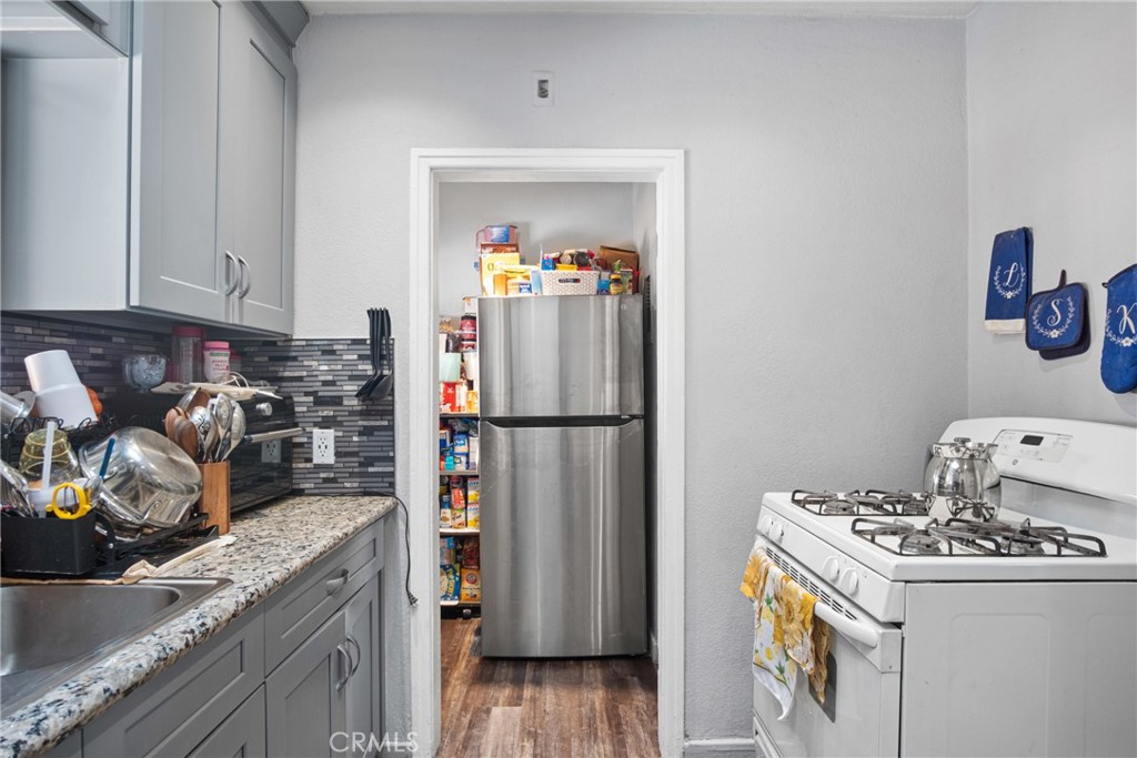 3420 Comer Avenue Riverside, CA 92507 - Photo 18 of 26 a kitchen with a refrigerator and a stove top oven