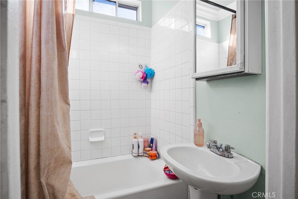 3420 Comer Avenue Riverside, CA 92507 - Photo 21 of 26 a bathroom with a sink and a mirror