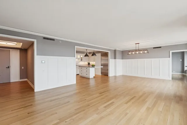 a view of a kitchen with wooden floor and a kitchen