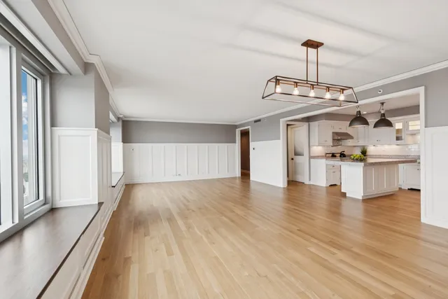 a view of a kitchen with a dishwasher and wooden floor