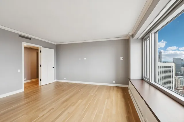 a view of a room with wooden floor and a window