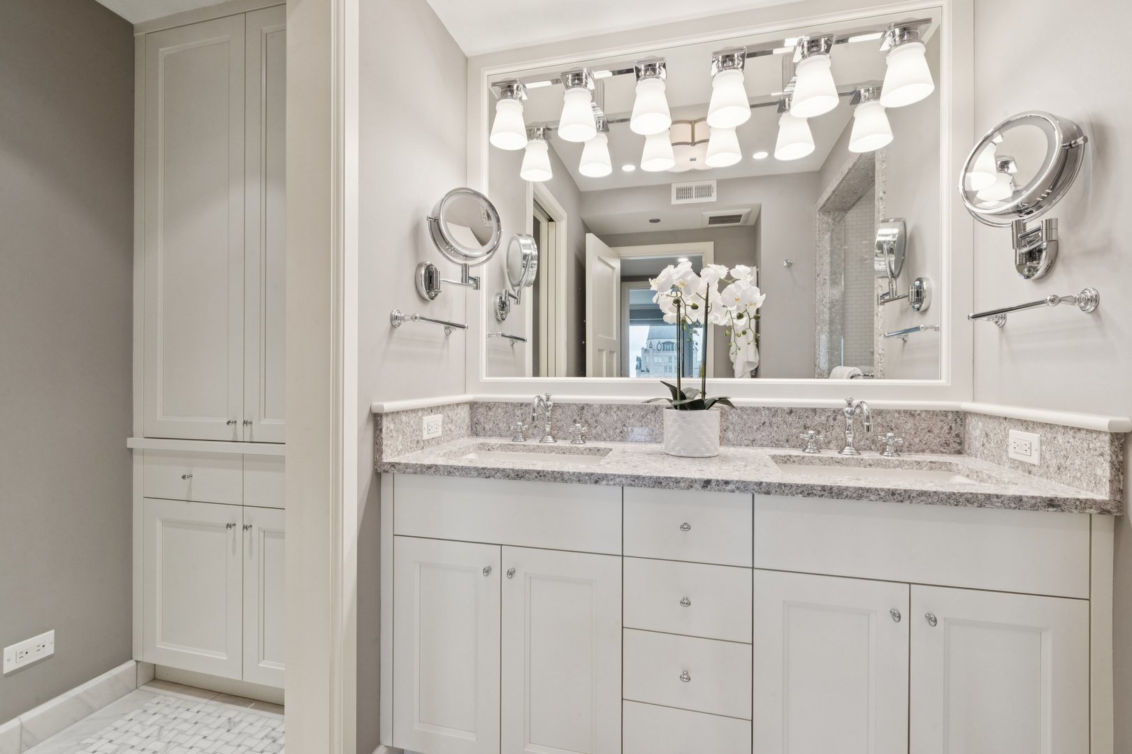 132 East Delaware Place, Unit 4803 Chicago, IL 60611 - Photo 25 of 53 a bathroom with a granite countertop sink and a mirror