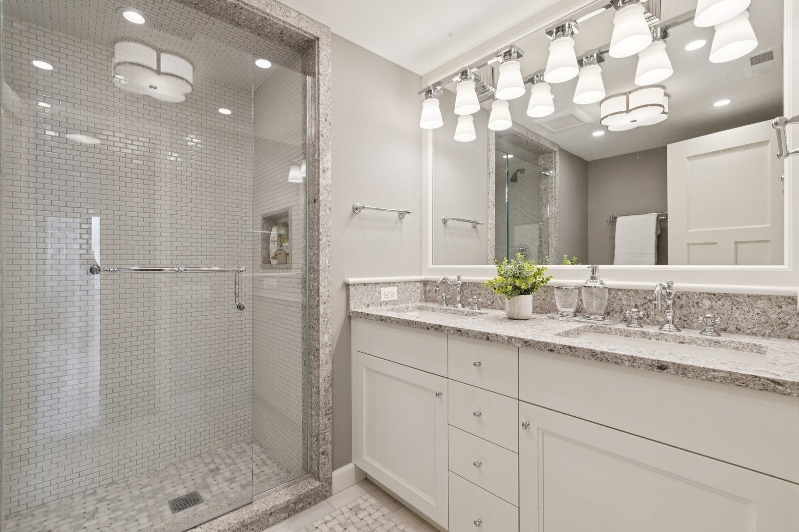 132 East Delaware Place, Unit 4803 Chicago, IL 60611 - Photo 34 of 53 a bathroom with a sink a large mirror and shower