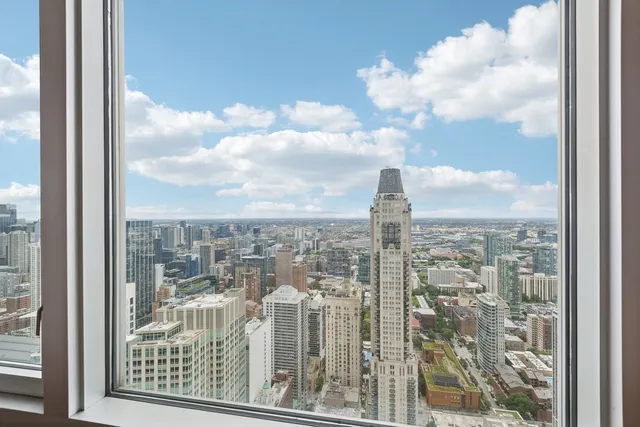 a view of a large room with wooden floor and windows