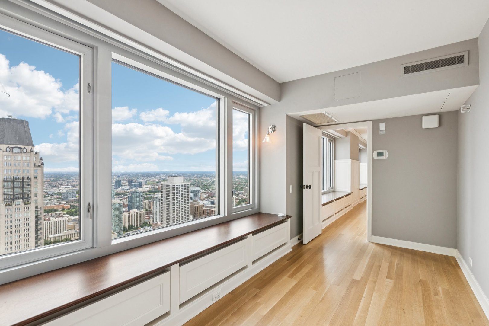 132 East Delaware Place, Unit 4803 Chicago, IL 60611 - Photo 37 of 53 a view of a large room with wooden floor and windows