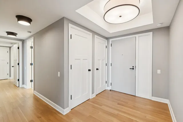 a view of a hallway with wooden floor and staircase