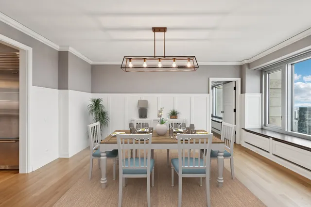 a view of a dining room with furniture wooden floor and chandelier