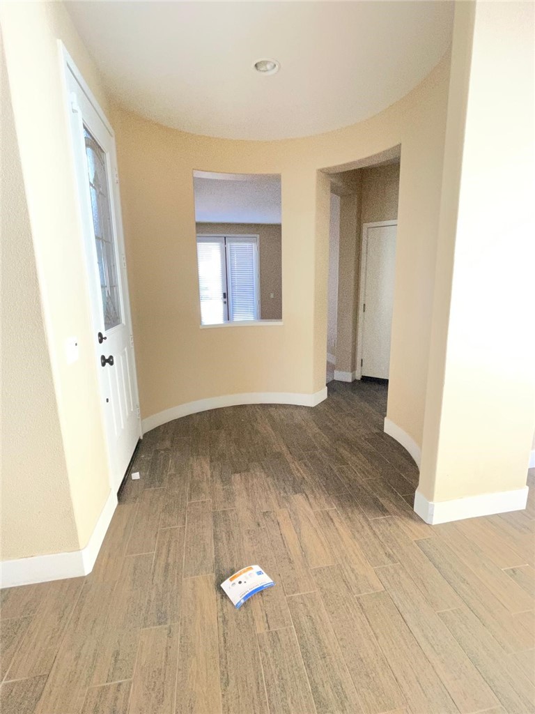 32689 Cottonwood Road Winchester, CA 92596 - Photo 16 of 25 an empty room with wooden floor and windows