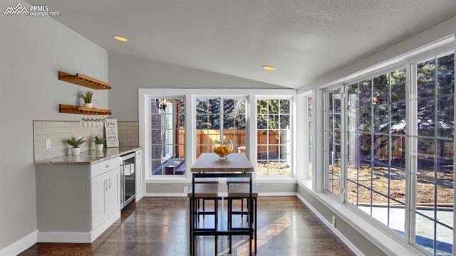 7850 Gardiner Road Cascade, CO 80809 - Photo 5 of 24 In addition to gorgeous granite counters, wine cooler, an those exceptional wood floors this kitchen features a special eating nook with windows to take in the views