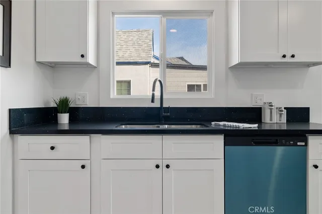 a kitchen with stainless steel appliances granite countertop a sink a stove and cabinets