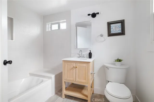 a white toilet sitting next to a bathroom sink