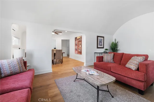 a living room with furniture and wooden floor