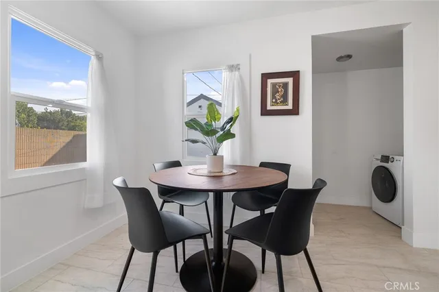 a view of a dining room with furniture window and outside view