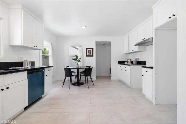 a kitchen with stainless steel appliances kitchen island granite countertop a sink and cabinets