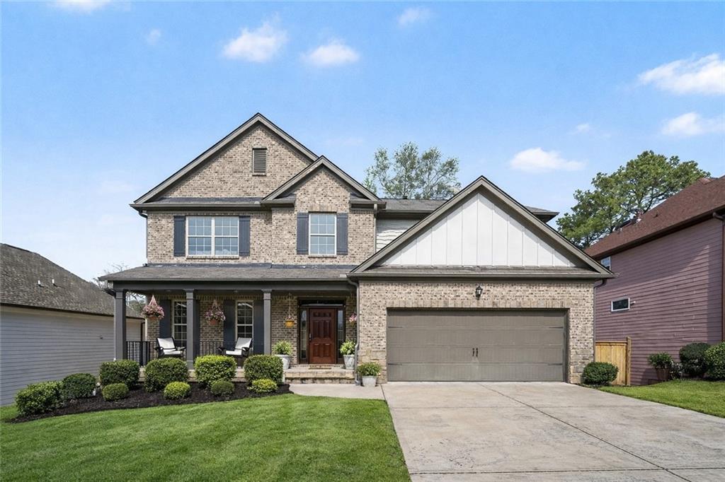 a front view of a house with a garden and plants