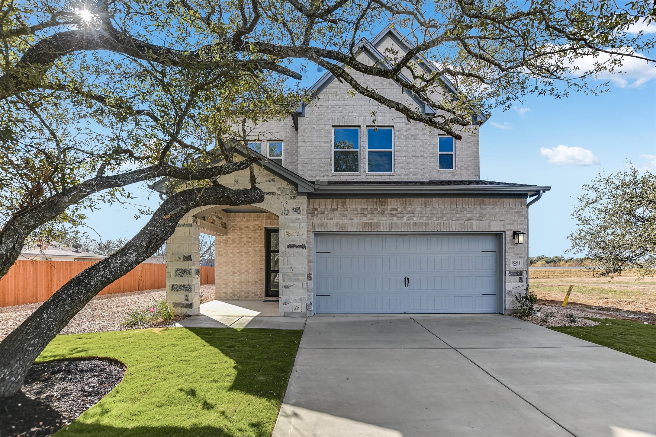 881 Prominence Way Leander, TX 78641 - Photo 1 of 1 a front view of a house with a garden and trees