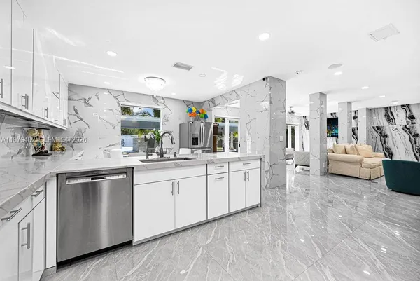 a large white room with lots of white stainless steel appliances
