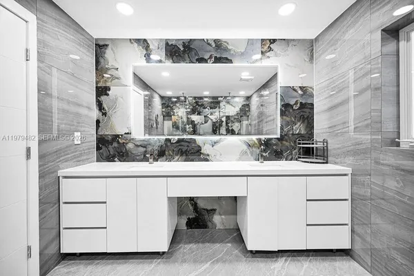 a kitchen with a refrigerator a stove top oven a sink and a window