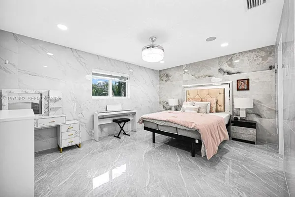 a bedroom with a bed and a television