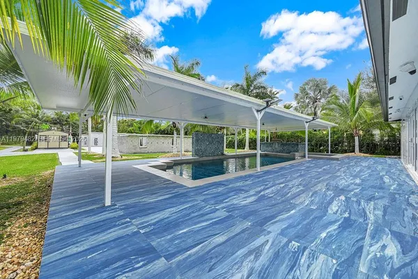 a view of swimming pool with a patio