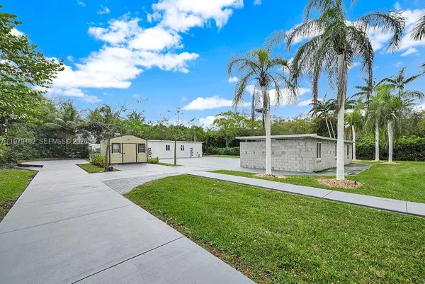 a view of a house with backyard and a tree