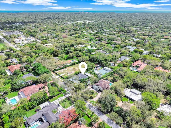 an aerial view of house with yard and garage