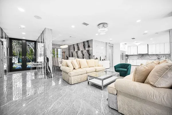 a living room with lots of furniture and a chandelier