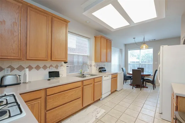 a kitchen with sink cabinets and window