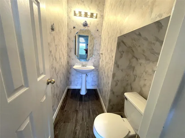 a bathroom with a toilet a sink and tub