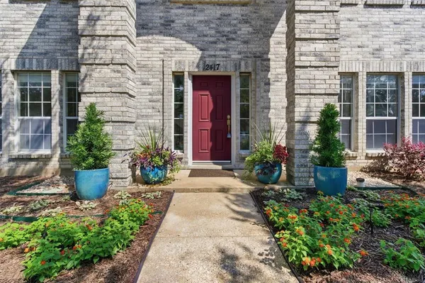 a front view of a house with potted plants
