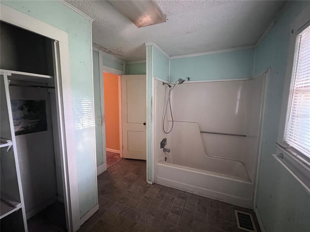 177 East 3rd Avenue Pierson, FL 32180 - Photo 14 of 16 a bathroom with a shower and a glass door
