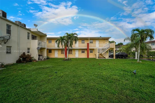 a view of a house with pool and a yard