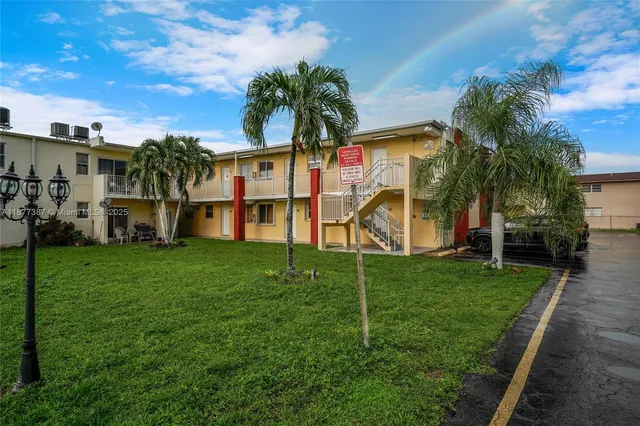 a view of a house with a yard and sitting area