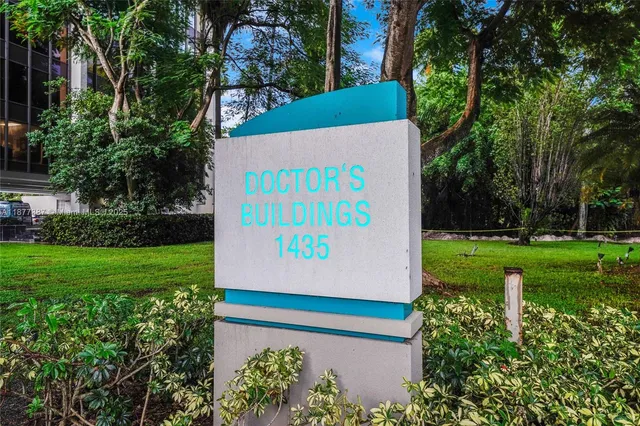 a view of a garden with a building in the background